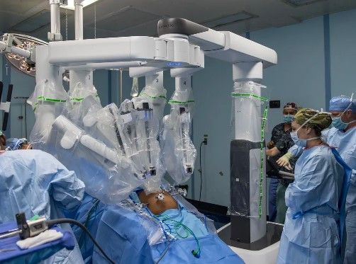 An image of one of a surgical robot performing laparoscopic surgery.
