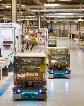 An image of autonomous mobile robots working at a warehouse.